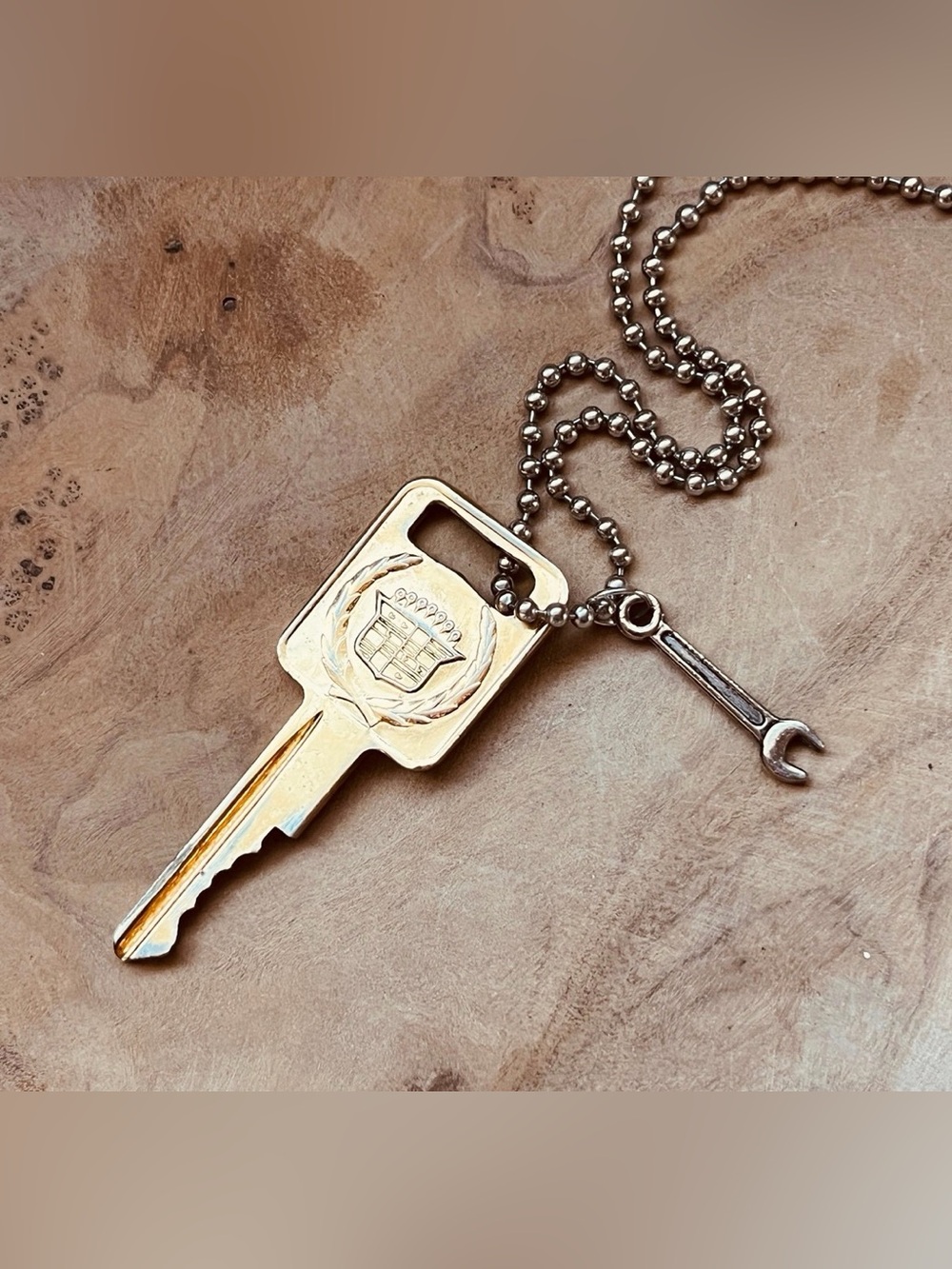 Vintage gold Cadillac crest key necklace with wrench charm